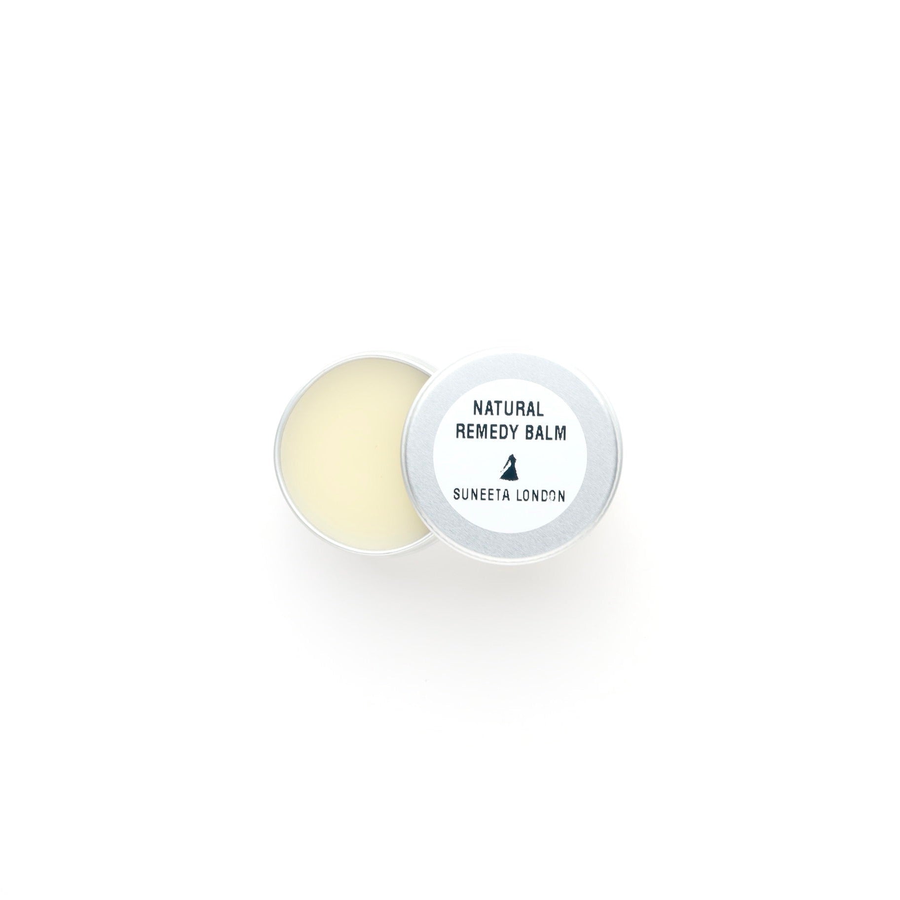 Round natural remedy balm with a white container on a white background
