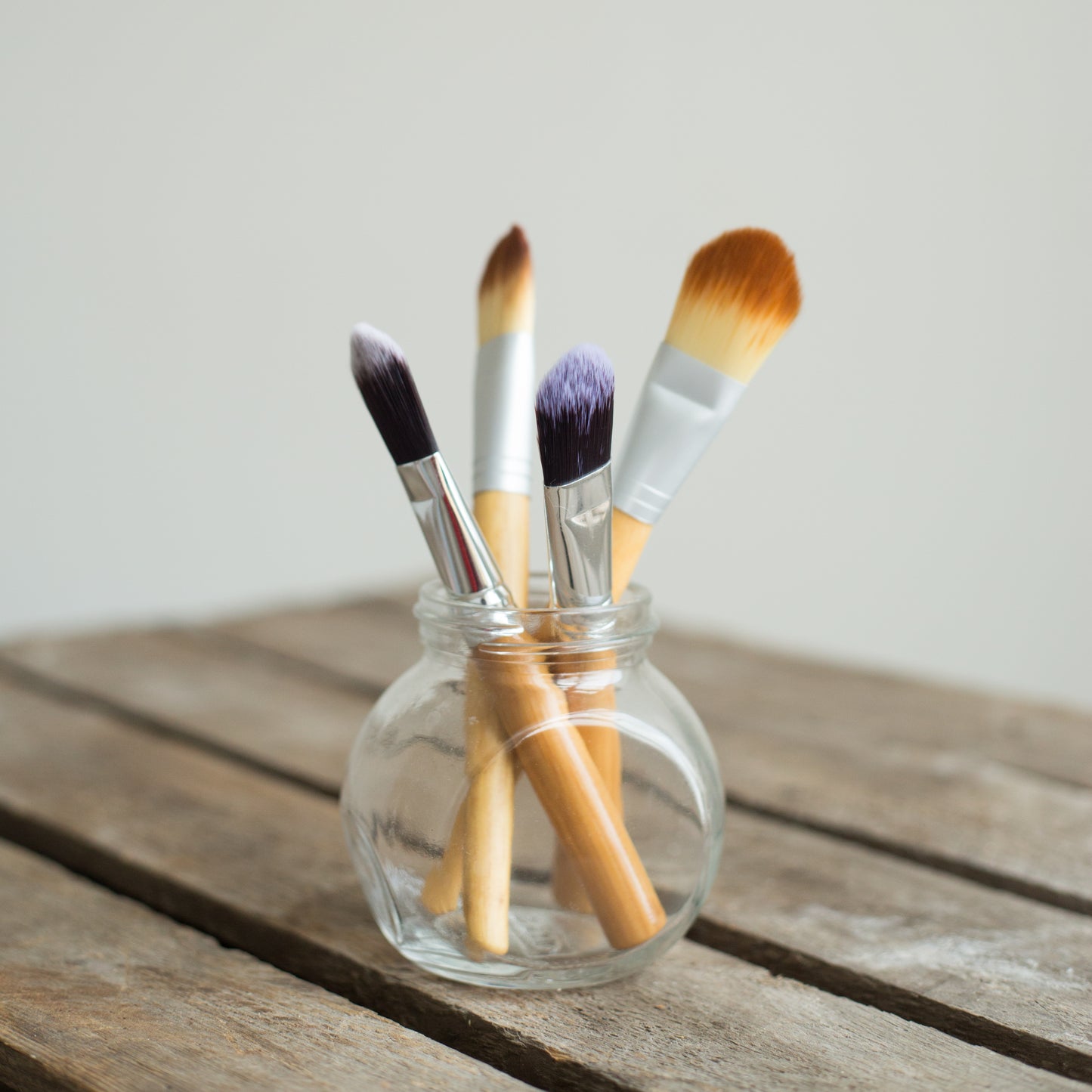 zero waste bamboo clay face mask brushes displayed without packaging in a glass jar